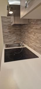 a kitchen with a sink and a stove at Casa Torri in Tarquinia +5 photos