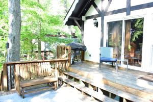 a porch with benches and a tree at Quiet and Comfy 3bed/2bath - Chalet with hot tub. in Cedar