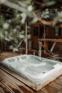 a bath tub sitting on top of a wooden deck at Wooden Nest in Durbuy