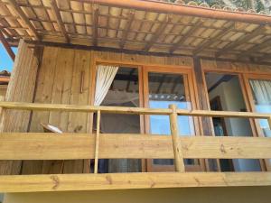 a wooden balcony of a house with windows at Pausa Trancoso in Trancoso