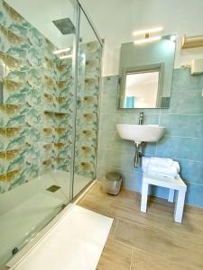 a bathroom with a sink and a shower at Campus Dei - Tropea Rooms in Tropea