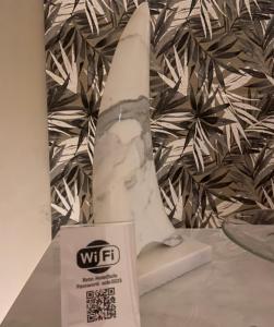 a white statue of a surfboard on a table at Hotel Sole in Marina di Massa