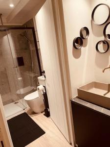 a bathroom with a shower and a toilet and a sink at Superb Chalet Monterosa in Anzino