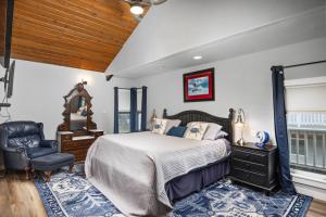 a bedroom with a bed and a chair at Once Upon a Tide in Rockaway Beach