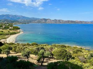 a large body of water with trees and a beach at Saint-Florent, Sublime Vue Mer plage 5mn à pied in Patrimonio