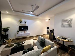 a living room with a couch and a table at Cozy minimal suite in Accra