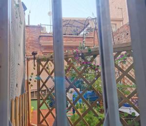a view of a garden from a balcony at Barcelona CoronaHostal in Badalona
