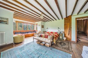 a bedroom with a bed and a couch at Amazing Arts & Crafts House in Robertsbridge