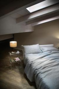 a bedroom with a large bed and a table at Corte San Luca Apartments in Bardolino