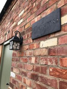 a sign on the side of a brick building at Stylish Barn Conversion with Woodland Views in Newark-on-Trent