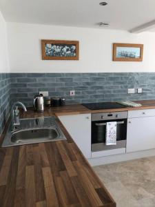 a kitchen with a sink and a stove at Stylish Barn Conversion with Woodland Views in Newark upon Trent