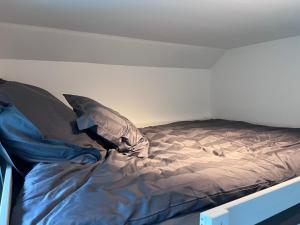a bed with two pillows on it in a room at Cozy room with smart solutions Grunerløkka Central in Oslo