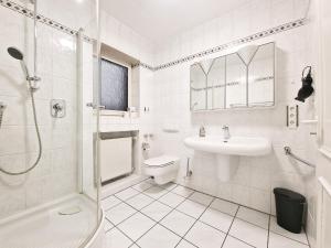 a bathroom with a sink toilet and a shower at Tolstov House - 6 Room House with Terrace and Parking - 30 Min Messe DUS in Mönchengladbach +27 photos