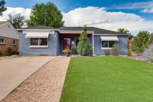 a blue house with a green lawn at Cozy Denver Home with Hot Tub, 2 miles to Dtwn! in Wheat Ridge