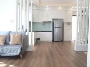 a living room with a couch and a kitchen at Ocean Dream Apartment Nha Trang in Nha Trang