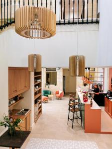 a kitchen with a bar and a dining room at Bloom Hostel Bar & Garden in Bordeaux