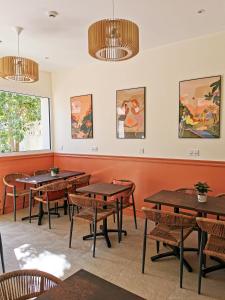 a dining room with wooden tables and chairs at Bloom Hostel Bar & Garden in Bordeaux
