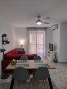 a living room with a red couch and a table at Apartamento El Lago Cartagena Centro. in Cartagena