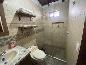 a bathroom with a toilet and a sink at Quinta Hotel Las Buganvillas in Ambato