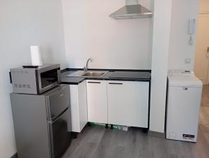 una pequeña cocina con fregadero y microondas en Estudio en Callao, 4 personas, en Madrid