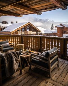 a balcony with a view of a snow covered mountain at Six Senses Residences & Spa Courchevel in Courchevel