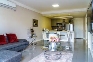 a living room with a couch and a table with flowers at Luxury Apartment at 20 South in Kingston