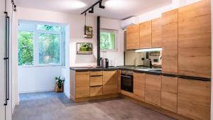 a large kitchen with wooden cabinets and a window at Start Apartments 3 in Bucharest