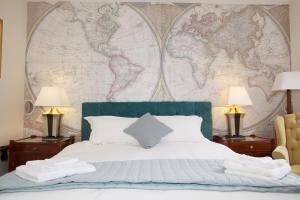 a bedroom with a bed with a map on the wall at The Captain Cook in London