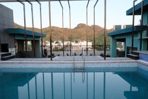 a pool of water in front of a building at Suvin Residency with Rooftop Swimming Pool in Udaipur