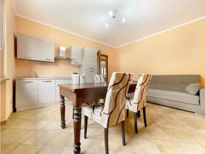 a kitchen and dining room with a wooden table and chairs at Il Gatto e la Tartaruga Appartamento in Grignasco +2 photos
