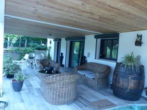 patio con sedie in vimini e soffitto in legno di Le volcan a Rochefort