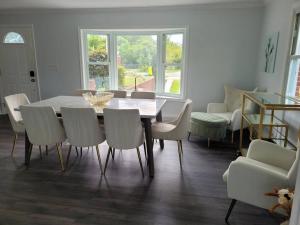 a dining room with a table and chairs at Serene 5 Bedroom Waterfront Retreat Near BWI in Glen Burnie