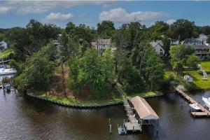 an island in the middle of a river with a dock at Serene 5 Bedroom Waterfront Retreat Near BWI in Glen Burnie
