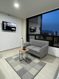 a living room with a couch and a table at Penthouse-Loft, Laureles, Vistas a Medellín - 801 in Medellín +10 photos