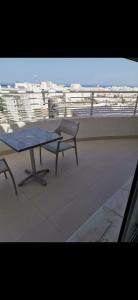 a table and chairs on a balcony with a view at Appartement panorama in Tunis