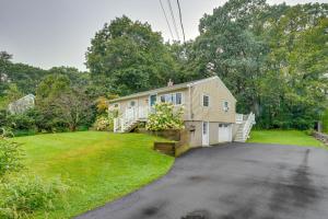a house with a driveway in front of a yard at Rye Coastal Retreat with Deck and Outdoor Dining in Rye