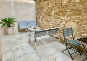 a patio with a bench and a table and chairs at JoliJoliette, terrasse, central, climatisé, WIFI , garage in Marseille