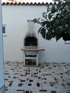 an outdoor brick oven sitting on a tiled floor at Big Dream 2 in Rovinj