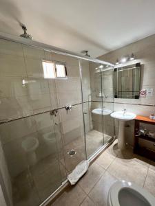 a bathroom with a shower and a sink at Hotel FK Paso de los Toros - Hotel Boutique in Paso de los Toros