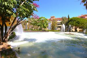 a large pool with a fountain in a park at Estepona Town Apartment CARMEN in Estepona
