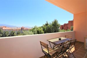 a table and chairs on a balcony with a view at Estepona Town Apartment CARMEN in Estepona