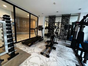 a fitness room with a gym with tread machines at Moda Condominium by Merryland in Chiang Mai