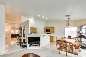 a kitchen and dining room with a table and a kitchen and a living room at Pet-Friendly Escape with Grill, 11 Mi to Strip! in Las Vegas