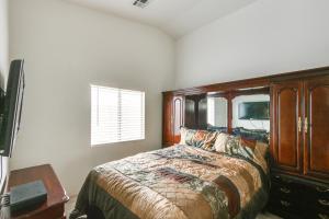 a bedroom with a bed and a table and a window at Pet-Friendly Escape with Grill, 11 Mi to Strip! in Las Vegas
