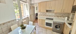 a kitchen with a washing machine and a table at Rest HOME in Getxo