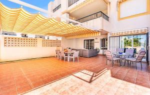 a house with a patio with a table and chairs at Apartamento El Toyo in Almería