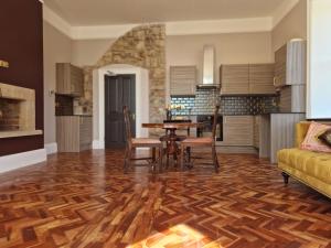 a kitchen with a wooden floor and a table and chairs at The Duke in Preston