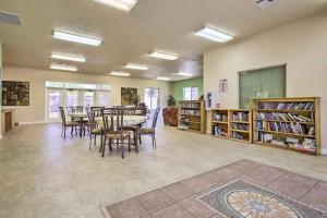 a library with tables and chairs and book shelves at Mesquite Vacation Rental Condo with Community Pool! in Mesquite