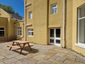 a wooden picnic table in front of a building at The Duke in Preston