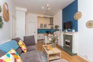 a living room with a couch and a table at Warm 1bed Flat Leith Walk in Edinburgh